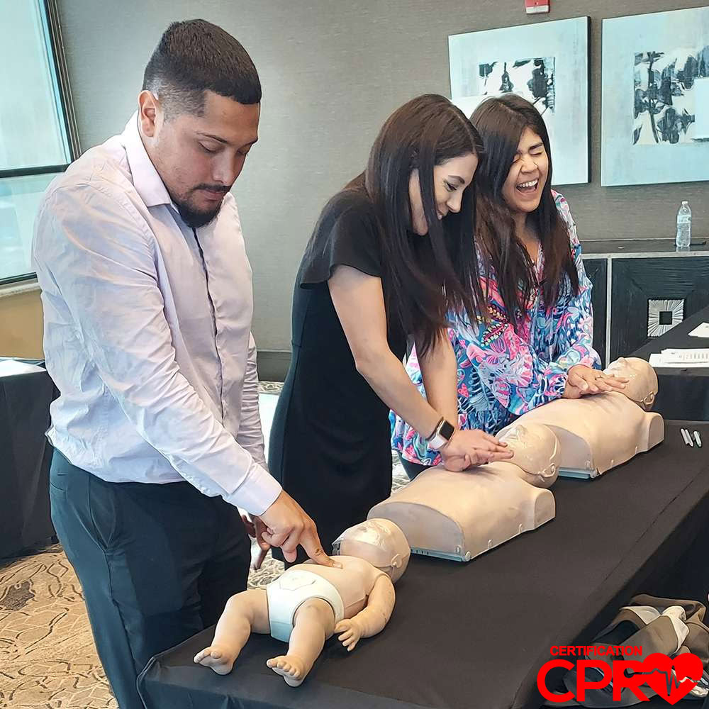 CPR training class in Laredo with students practicing on mannequins.