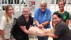 Group CPR training session in Laredo with instructor and students.